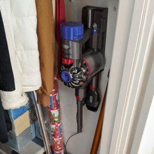 Dyson V8 Absolute mounted in a small closet.