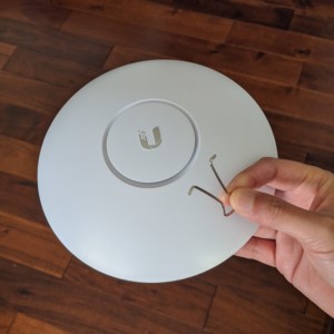 Using a binder clip end to reset a Unifi Access Point (from Ubiquiti)