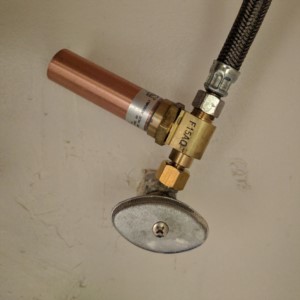 Water Hammer Arrestor installed under the sink of a bathroom.