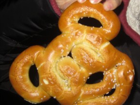A Mickey Mouse shaped pretzel, lighted salted. The pretzel from a cart was warm, and tasted like any other pretzel.