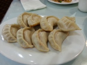 A plate of 8 potstickers. They look perfect on the outside. On the inside, they're full of hot juice, though the juice isn't very fatty, nor flavorful. The skin was surprisingly thick.